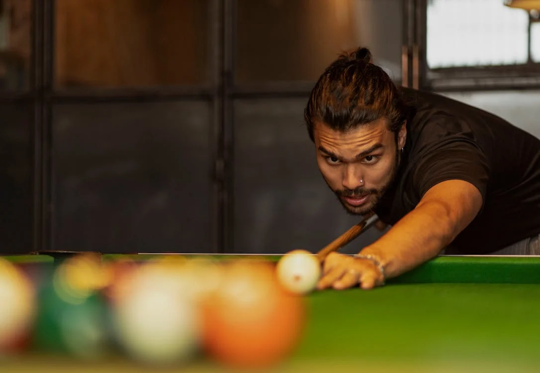 Pool player taking a break shot