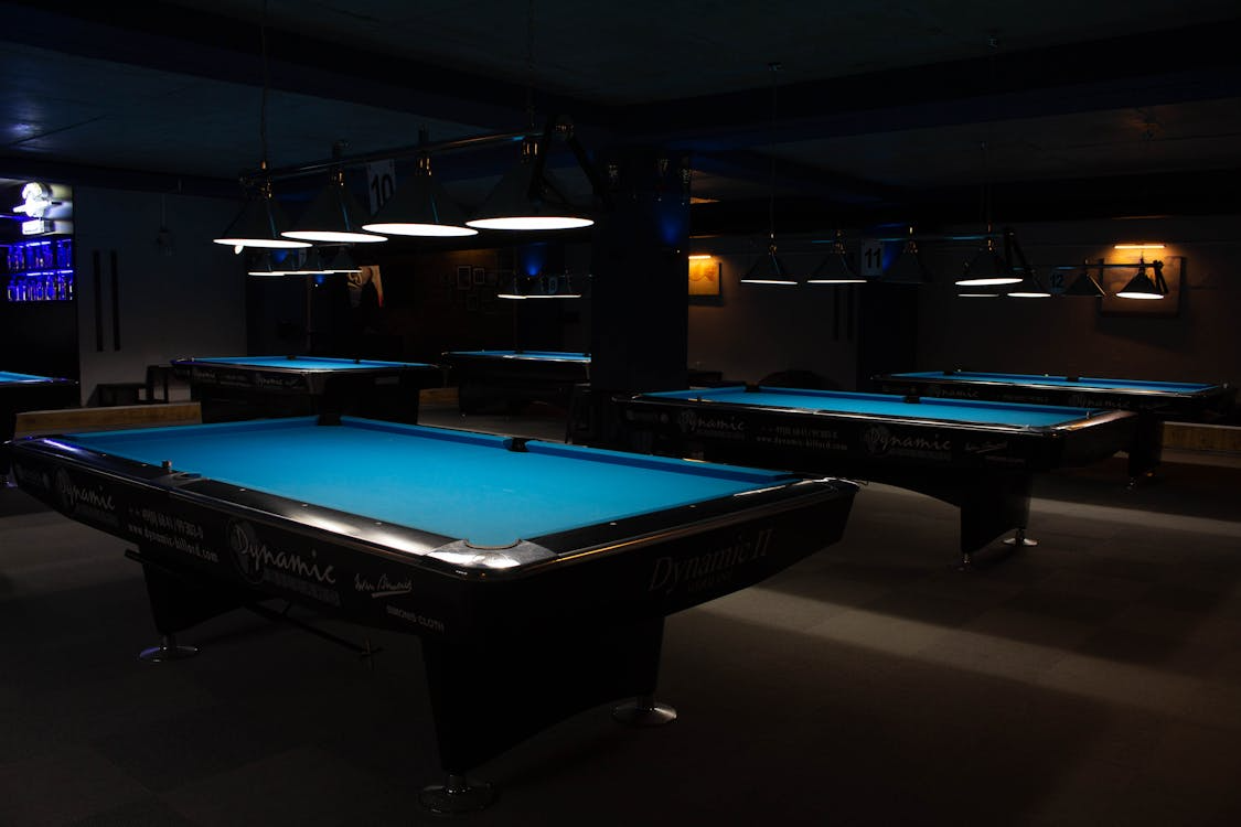 Blue billiard tables in a pool hall